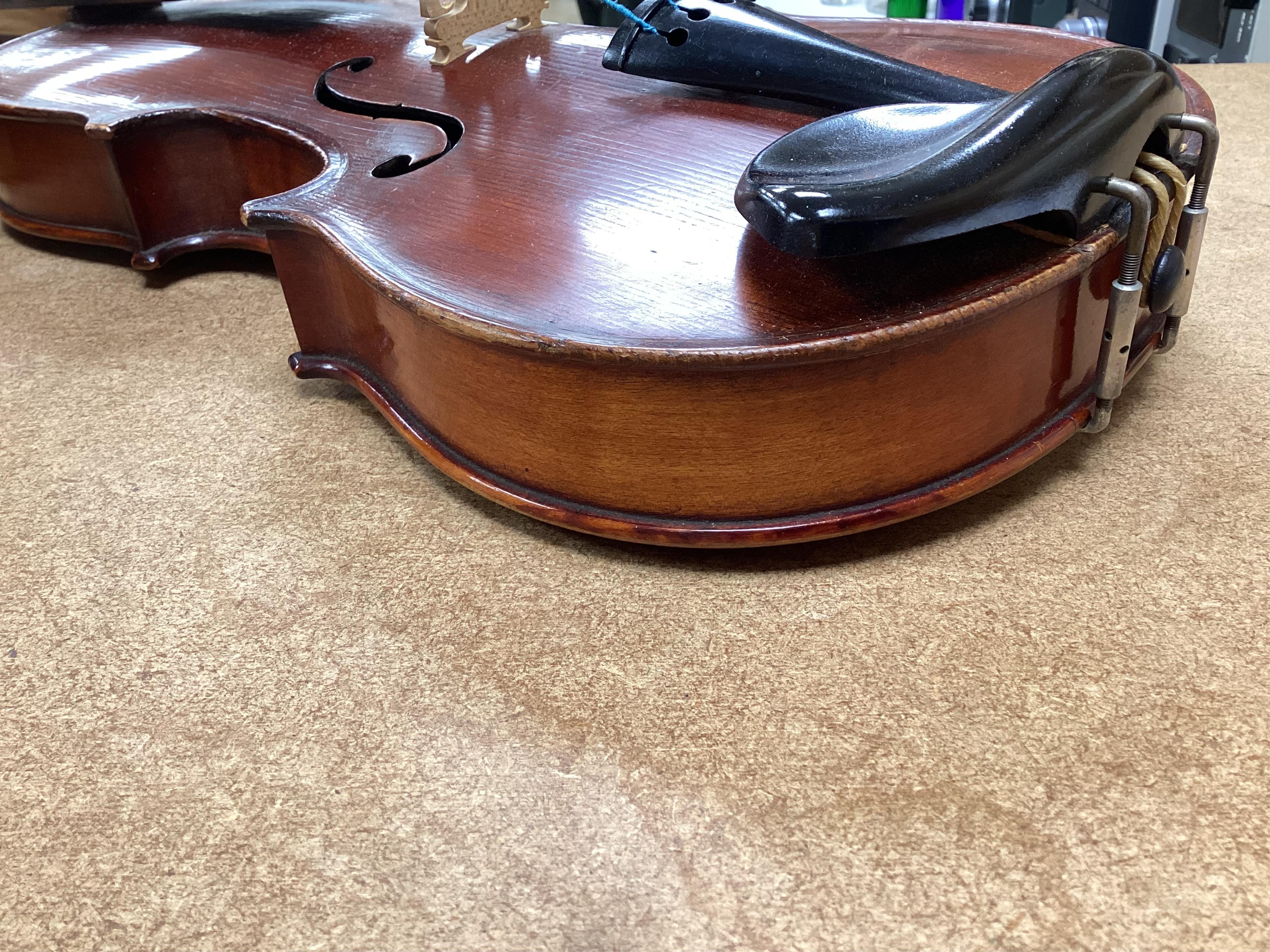 A cased late 19th century German Mittenwald violin with lion’s head scroll, and two bows, Ivory submission ref: RP2E5HT1